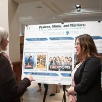 Brittany Bahl discussing her poster with the Assistant to the Associate Vice-Provost of The Graduate School, Irene Fountain